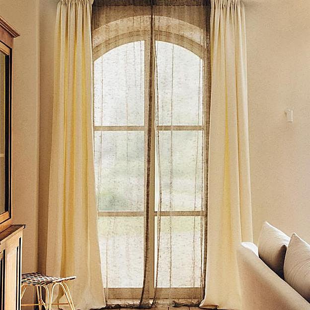 Imagen principal - Cortinas de red rebajadas a 29.99 euros; lámpara de pie en ratán, 69.99 euros. Lámpara de mimbre con pie dorado, rebajada a 149 euros en Zara Home.