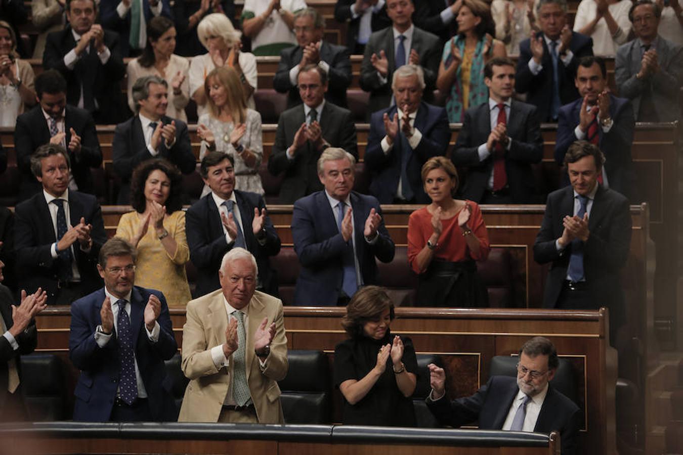 La bancada del Partido Popular aplaude la intervención de su dirigente.