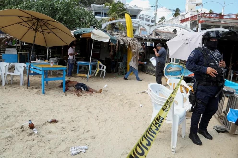 A body lies shot on an Acapulco beach