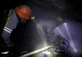 Dos mineros trabajan en un pozo situado en la zona andina de Perú, en una imagen de archivo.