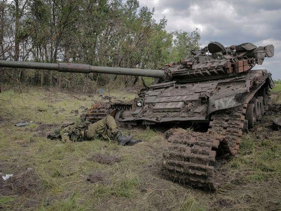 A Russian soldier lies dead next to a wrecked tank on the Donetsk front, in what is still called the 'Surovikin line' of defense against invading troops.