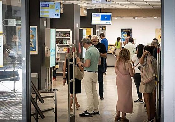 Ciudadanos hacen cola en una oficina de Correos.