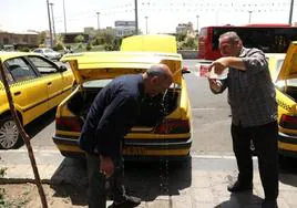 Taxistas iraníes se refrescan en Teherán, en plena ola de calor.