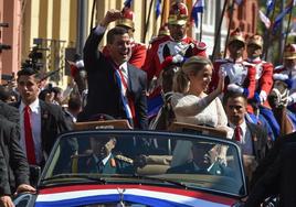 El nuevo presidente de Paraguay, Santiago Peña, y su esposa, Leticia Ocampos, saludan a sus seguidores tras prestar juramento en Asunción.