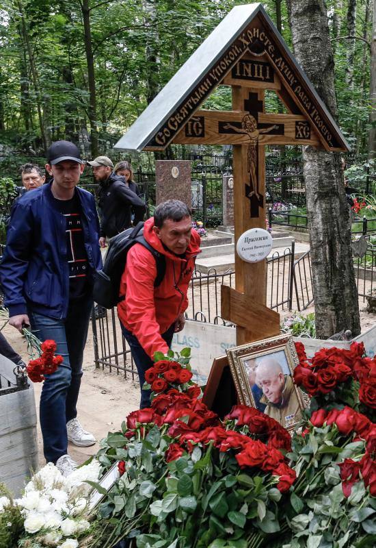 Imagen secundaria 1 - Varios momentos de la peregrinación ante la tumba de Prigozhin