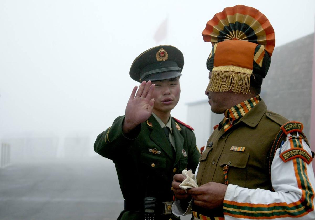 Un guardia fronterizo chino junto a uno indio