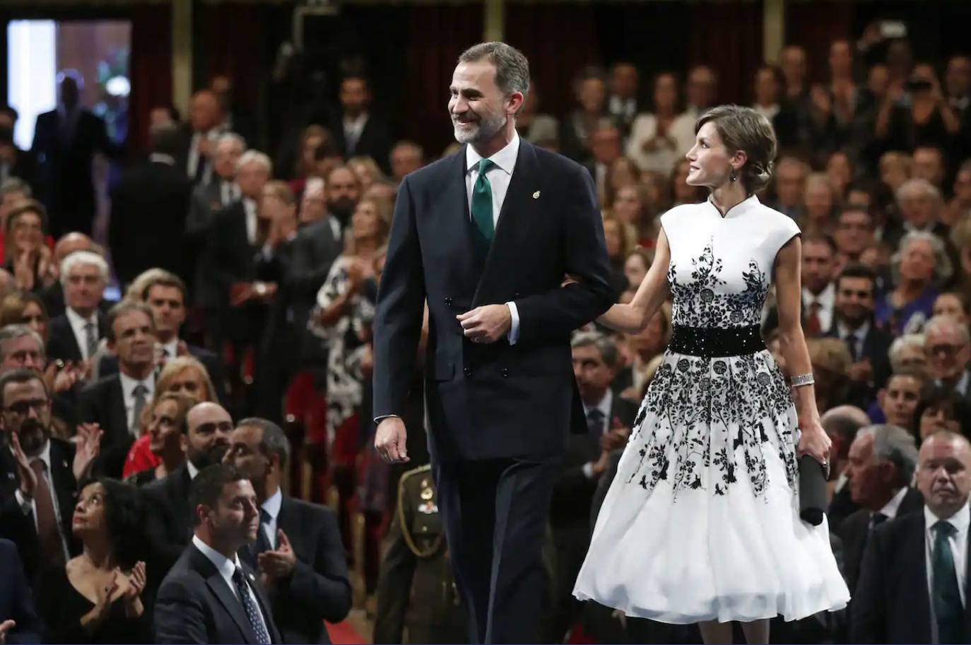 2017. La Reina cambió las siluetas de los años anteriores por una favorecedora 'new look' de inspiración oriental en georgette de seda blanco bordado en hilo y cristal negro, con un favorecedor cuerpo entallado con cuello Mao y cinturón joya. Este 'look' fue un punto de inflexión en los estilismos para la destacada cita. Para mejor.