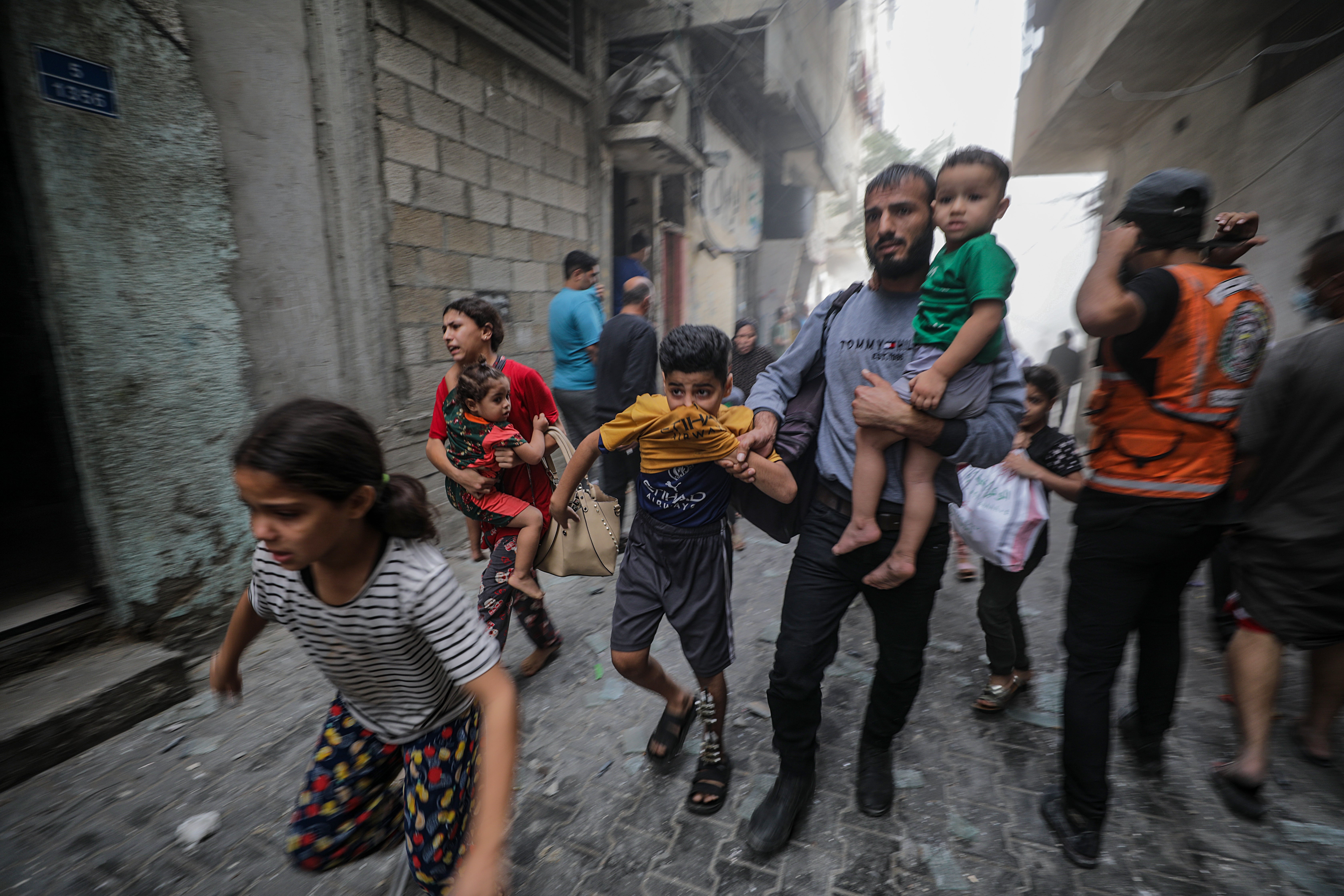 Ciudadanos palestinos huyen de los bombardeos.