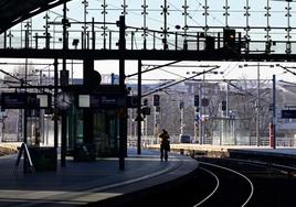 Un hombre toma fotografías a un andén desierto de la estación principal de trenes de Berlín.