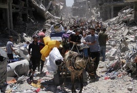 Familias palestinas observan los daños en Yabalia tras la retirada de las tropas israelíes.