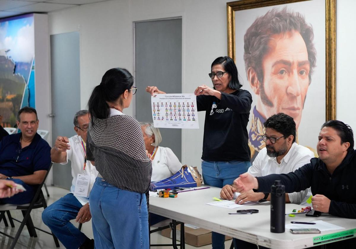 Una imagen de Simón Bolívar preside un colegio electoral venezolano, donde algunos presidentes de mesa tuvieron que explicar el funcionamiento del proceso.