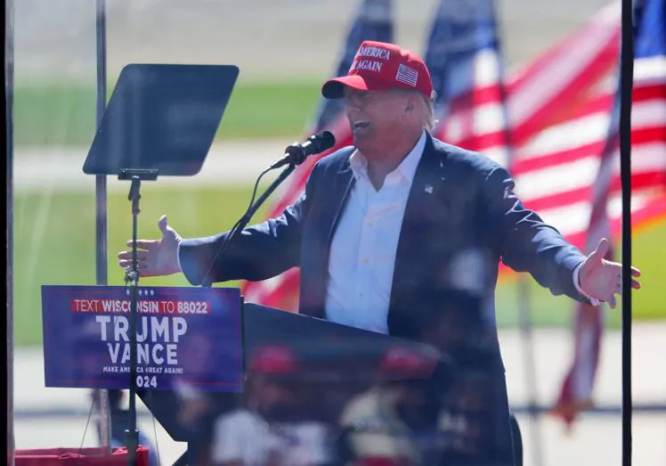 Donald Trump has to hold his rallies behind bulletproof glass.