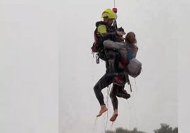 Un miembro de la Unidad Militar de Emergencias rescata a una mujer en Utiel esta mañana.