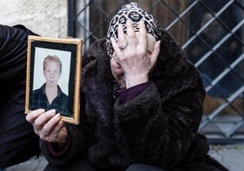 Una mujer llora tras hallar el cadáver de uno de sus hijos en Damasco.