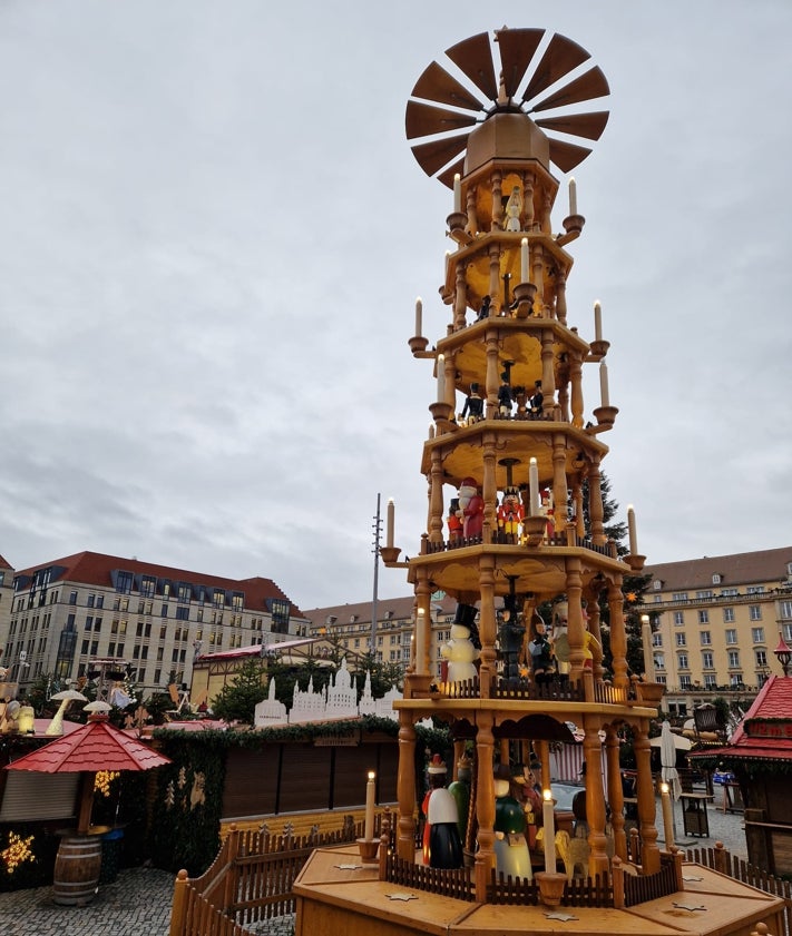 Imagen secundaria 2 - El típico arco de luces de Dresde da la bienvenida al mercadillo más antiguo del mundo. Una vista nocturna del Striezelmarkt y la tradicional pirámide navideña de madera, que mide casi 15 metros.