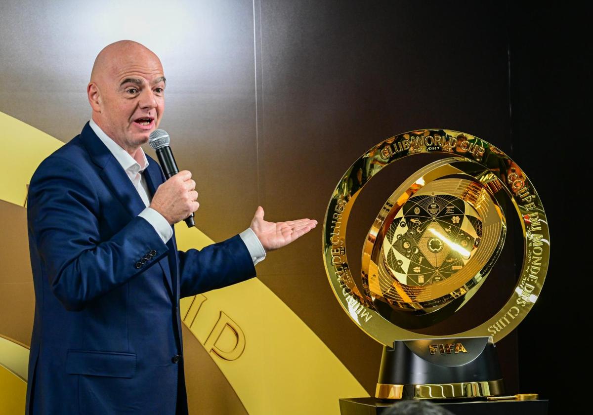 Gianni Infantino, FIFA President, alongside the Club World Cup trophy.