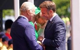 Carlos III y Emmanuel Macron se saludan afectuosamente en Windsor.