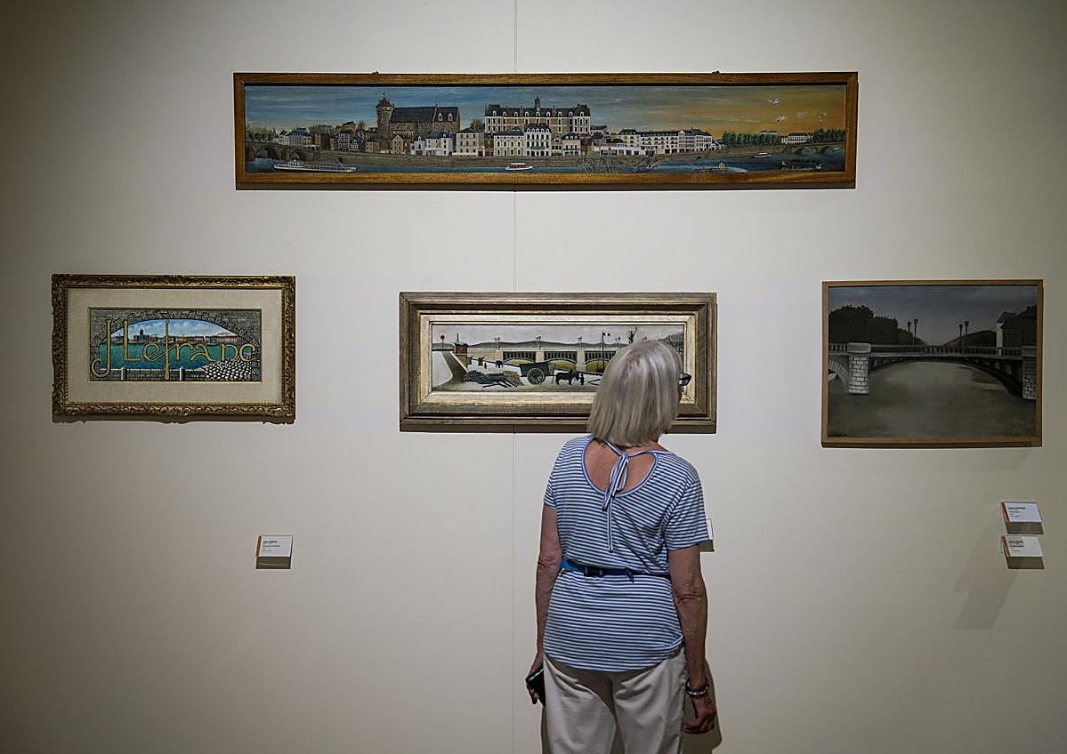 Imagen secundaria 1 - Arriba, casas de entramado de madera, típicas del casco medieval. A la izquierda, una mujer observa varias obras en el Museo de Arte Naif y Artes Singulares ubicado en el castillo de Laval. A la derecha, la puerta Beucheresse, en cuya torre nació el pintor naíf Henri Rousseau.