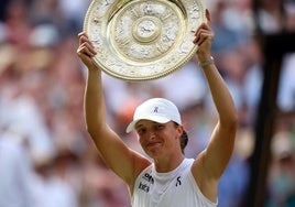 Iga Swiatek levanta el trofeo que la acredita como campeona de Wimbledon.