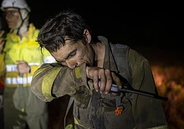 Un bombero forestal ayer por la noche en la localidad de Argayo del Sil (León), que ha sido desalojada.