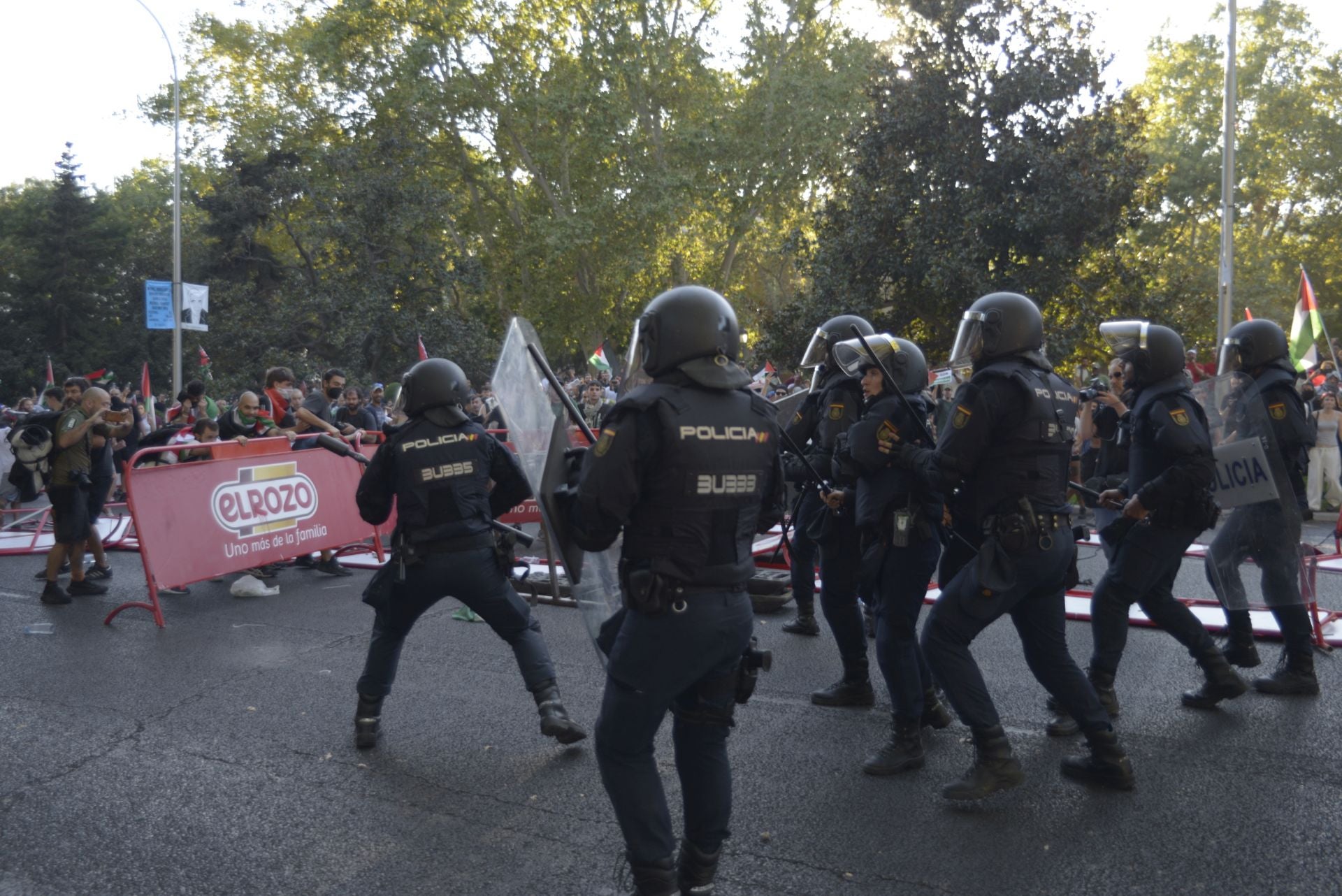 Varios manifestantes utilizan una valla publicitaria para enfrentarse a la Policía