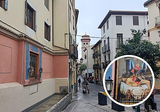 Pilar de la Virgen en calle Elvira de Granada. En el círculo, las pegatinas sobre la mampara de cristal.