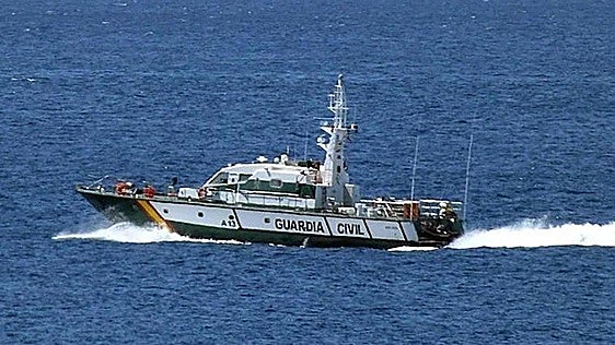 Una patrullera de la Guardia Civil, auxiliada por un helicóptero para no acabar hundiéndose