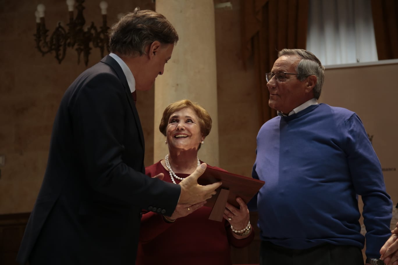 El alcalde de Salamanca entrega una placa a un matrimonio. 