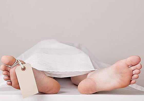 Cuerpo de un fallecido cubierto por una sábana.