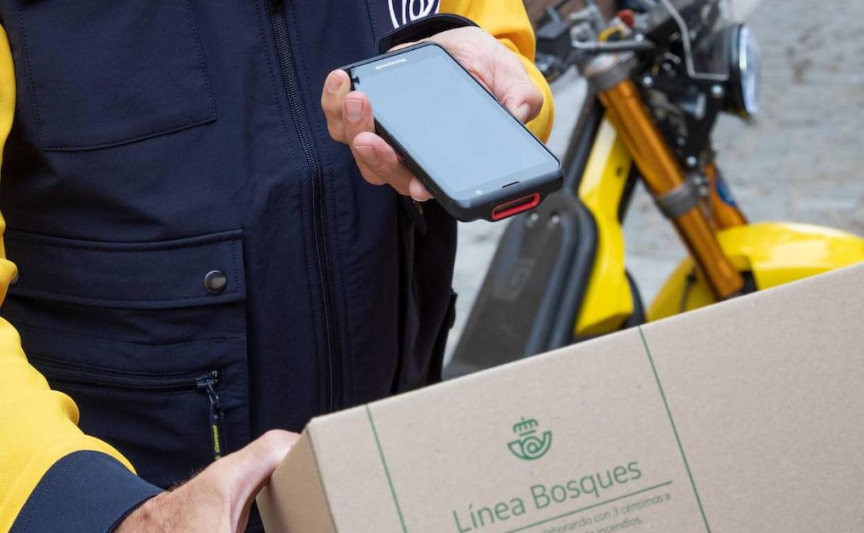 Un cartero rural dotado con un dispositivo portátil (PDA). 