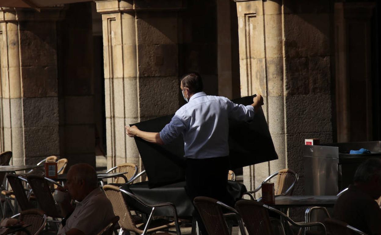 Un camarero prepara una mesa en la Plaza Mayor.