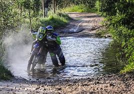 Lorenzo Santolino sale del enorme pozo con la moto en la mano.