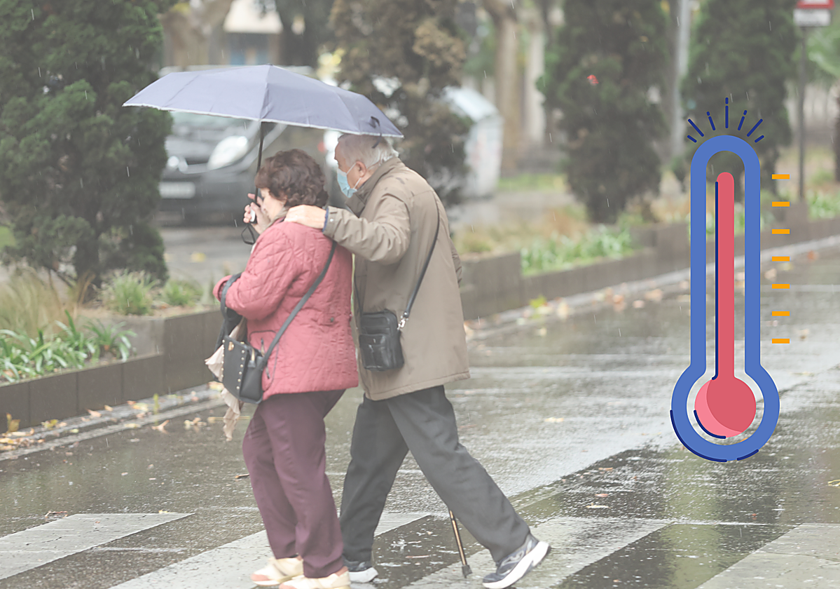 Dos personas se cubren bajo el paraguas ante la lluvia