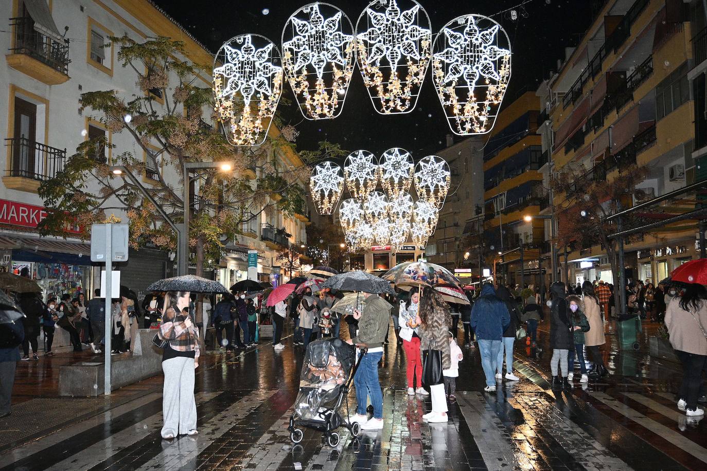 Crowds gathered at Marbella's Christmas lights despite the threat of rain.
