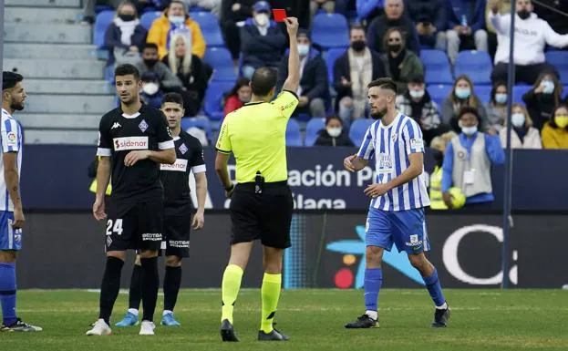 Genaro being shown a red card in Malaga's defeat to Amorebieta. 