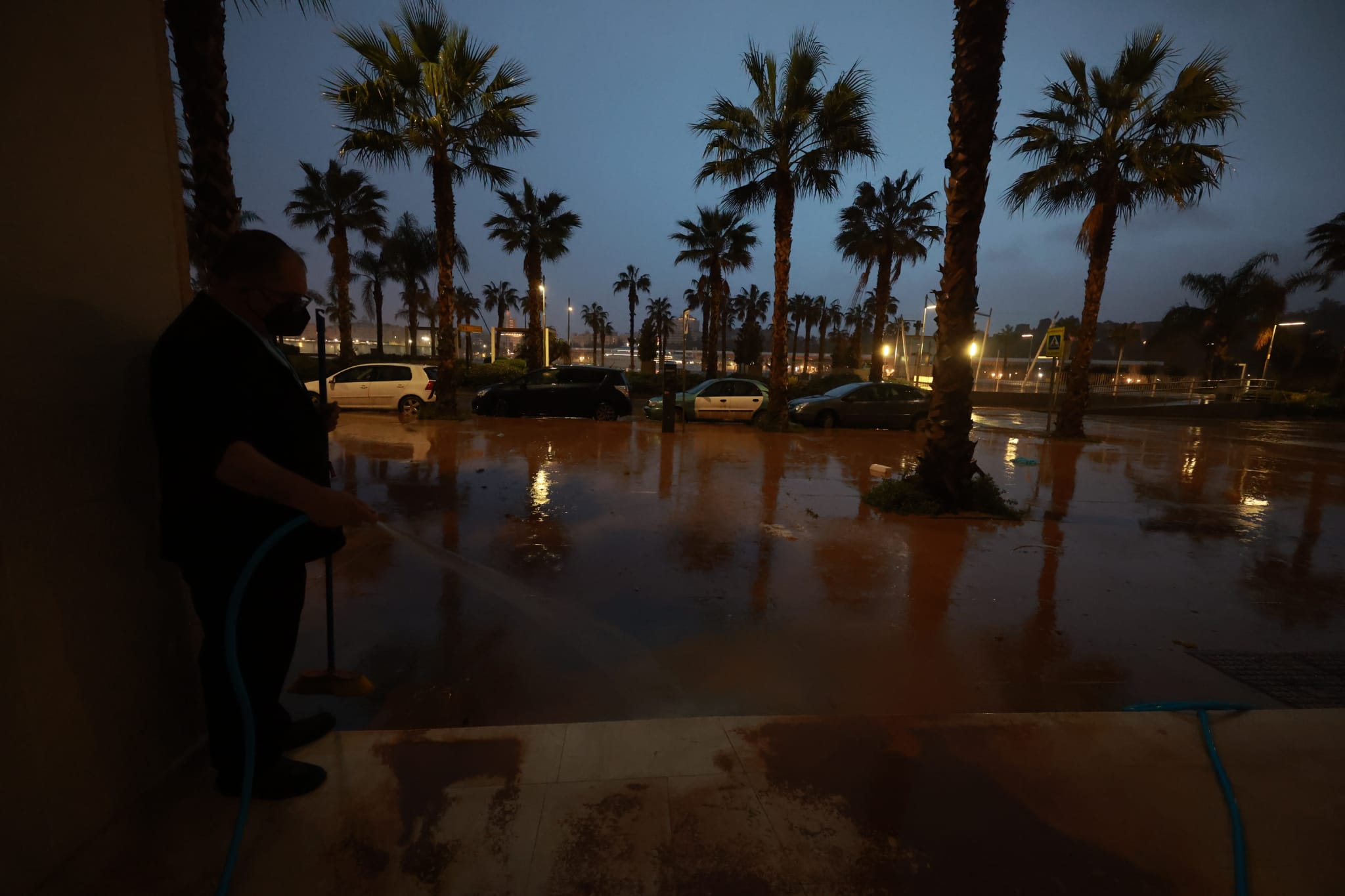 Malaga wakes to cars, buildings and streets covered in red mud