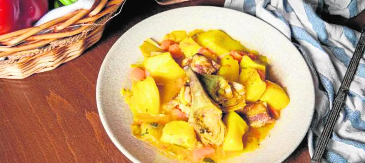 A cazuela of potatoes and pork chops, from the Arriate Bar in Malaga, which is enriched with artichokes in Springtime. 