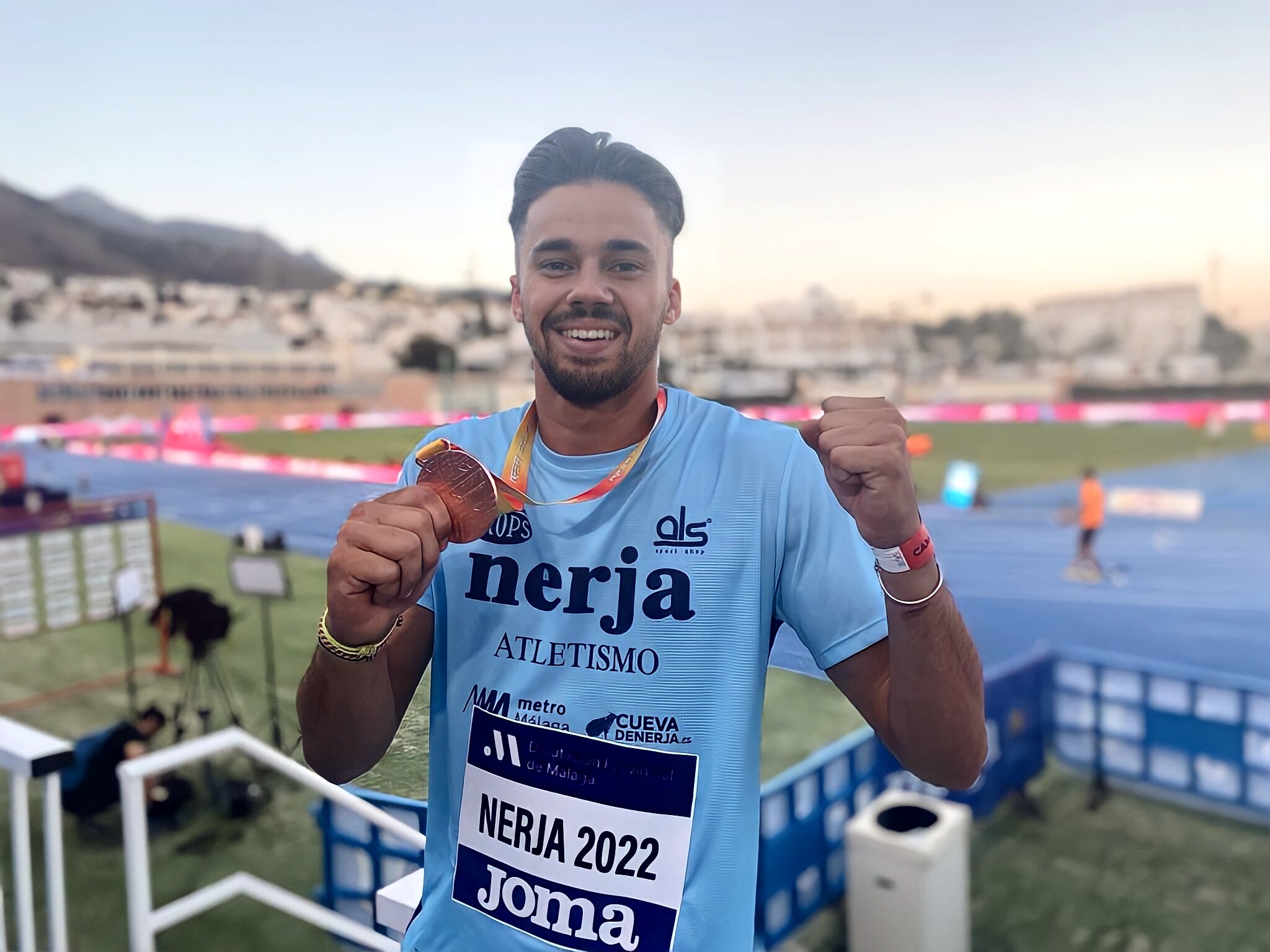 Isidro Leyva poses with his bronze medal after the pole vault event. 