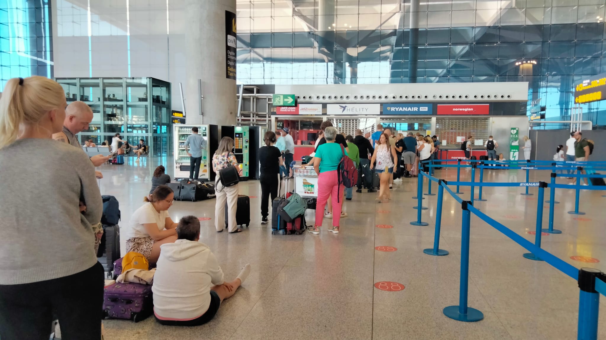 Passengers queue for the Ryanair desk at Malaga Airport this Sunday.