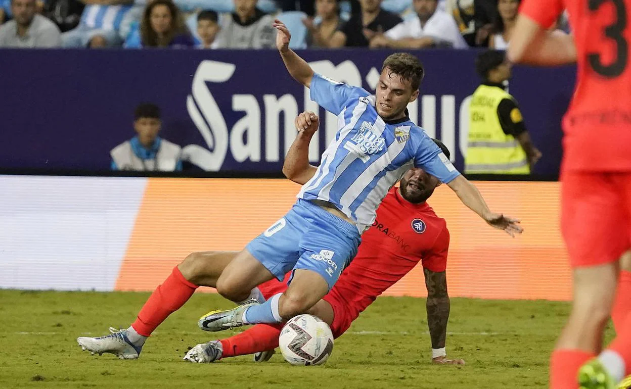 Aleix Febas is tackled by an Andorra during Malaga's goalless draw. 