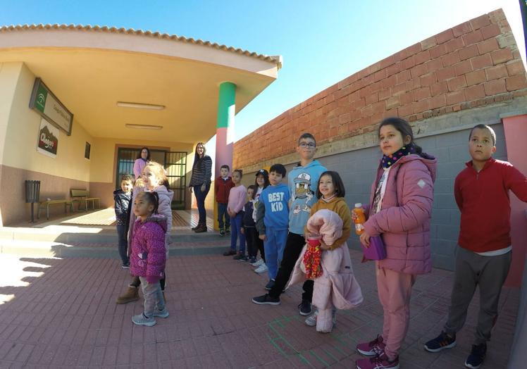 Children in Corumbela stand in two lines, one for each class.