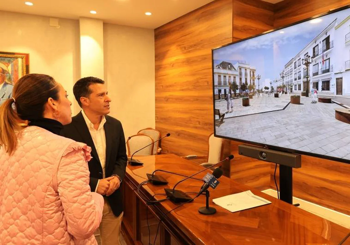 Medina and Moreno look at a computer image of what the plaza will look like