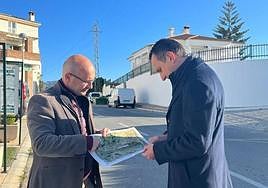 Examining the plans for the works.