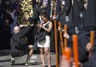 Tourists capture the Easter processions in Malaga.