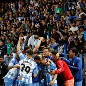 The Malaga players celebrate the winning goal on Monday night.