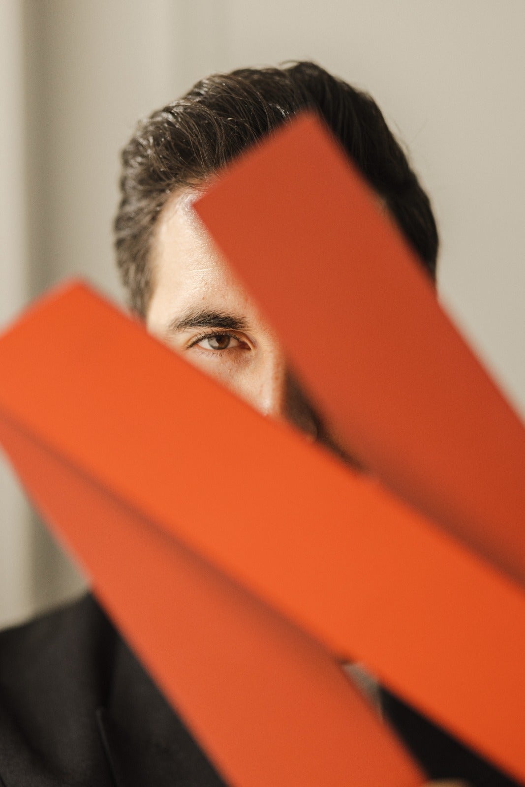 Writer Javier Castillo peers from behind the Netflix logo, where his next adaptations will be seen.