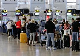 Stock image of passengers at Malaga Airport.