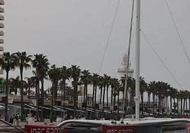 The trimaran in Malaga's mega yacht marina, with the lighthouse in the background.