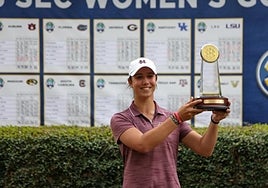 López poses with the winner's trophy.