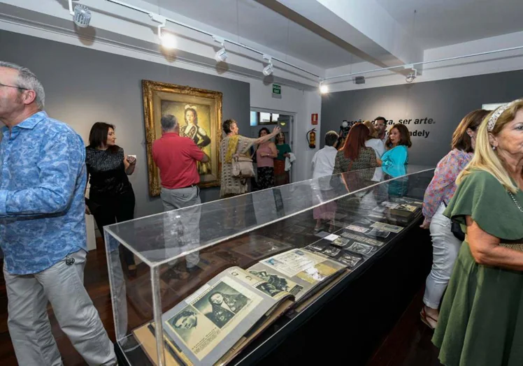 The exhibition includes memorabilia, photographs and dresses.